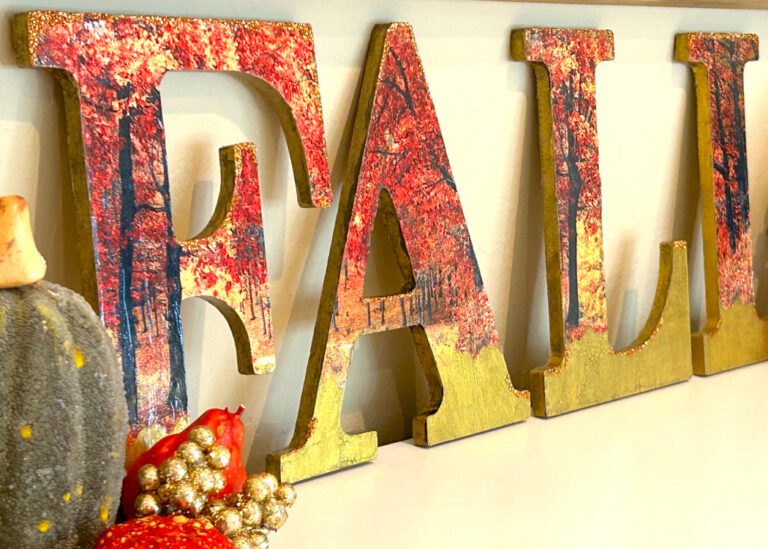 Decoupaged wood letters displayed with pumpkins