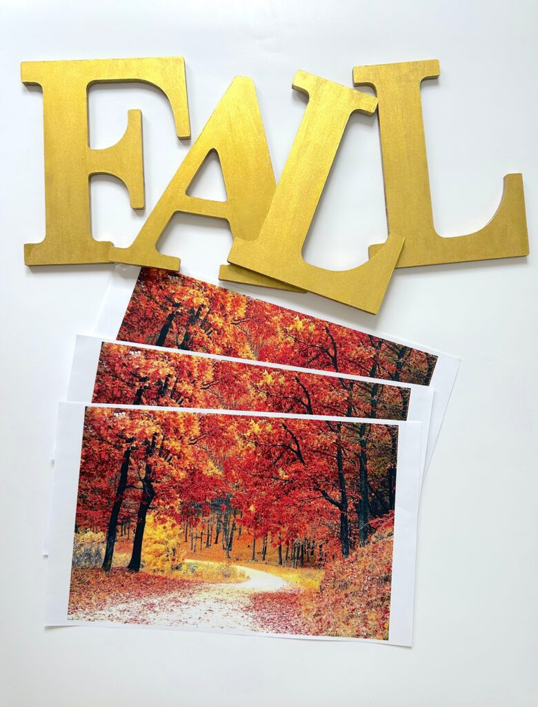 Wood letters being painted with Plaid gold paint