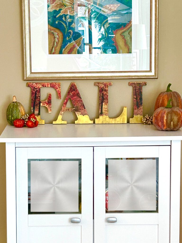 Decoupaged fall wood letters on cabinet