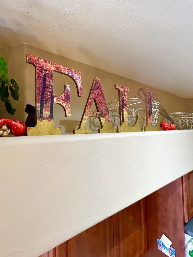 how to decoupage wood letters for fall on plant shelf in kitchen