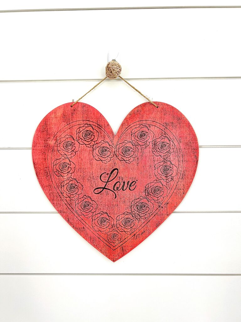 Distressed heart hanging on a shiplap wall