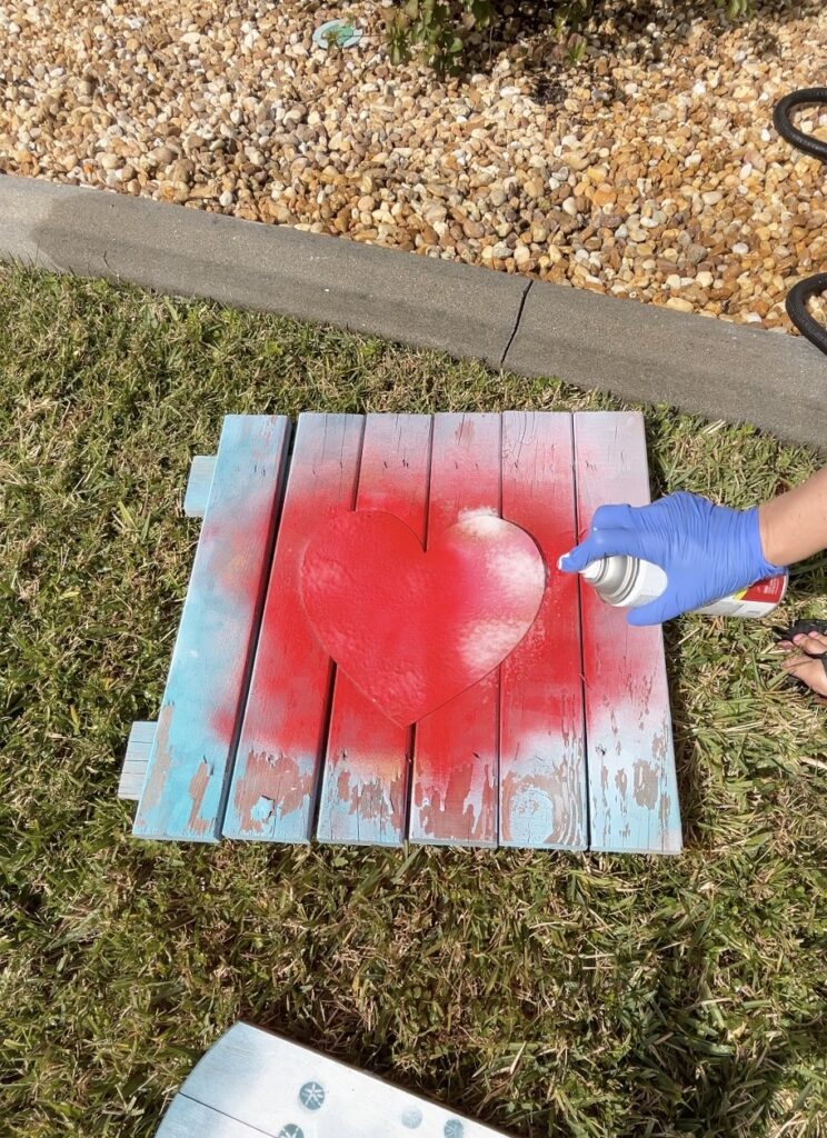 Spraying red paint over Dawn Power Wash