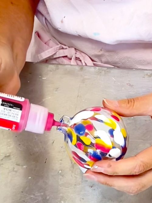 Squirting Plaid Murano paint into the glass ornaments