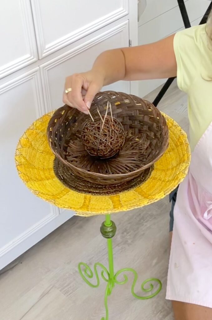 Adding toothpicks to the twine ball as a toothpick holder for appetizers