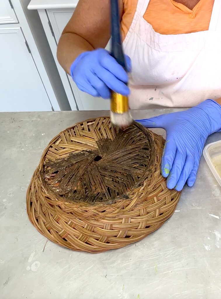 Using a stencil brush to paint a basket
