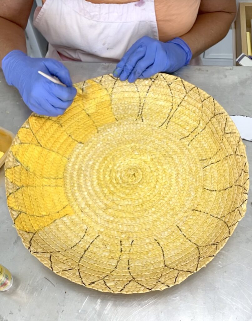 painting the sunflower on the flat basket