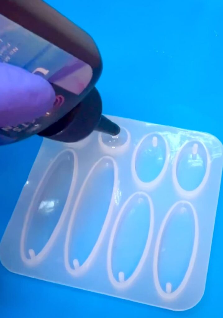 Pouring UV resin into silicone earring mold