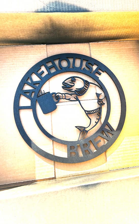 Fish drinking coffee sign painted black with Lakehouse Brew