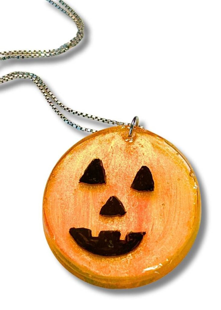 finished resin pumpkin charm on a chain