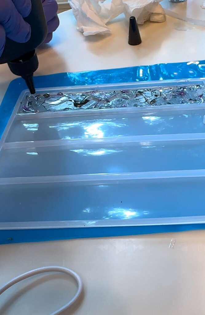 Adding another layer of UV resin to the ghost bookmark