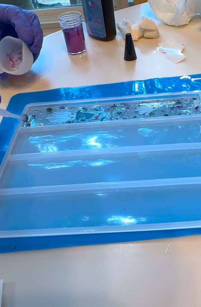 Adding glitter to the ghost bookmark