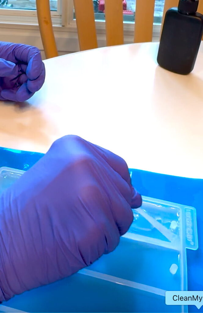 Smoothing the UV resin for the DIY bookmark