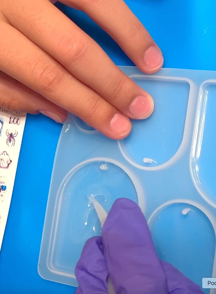 Adding UV resin to the silicone mold for crafting fun