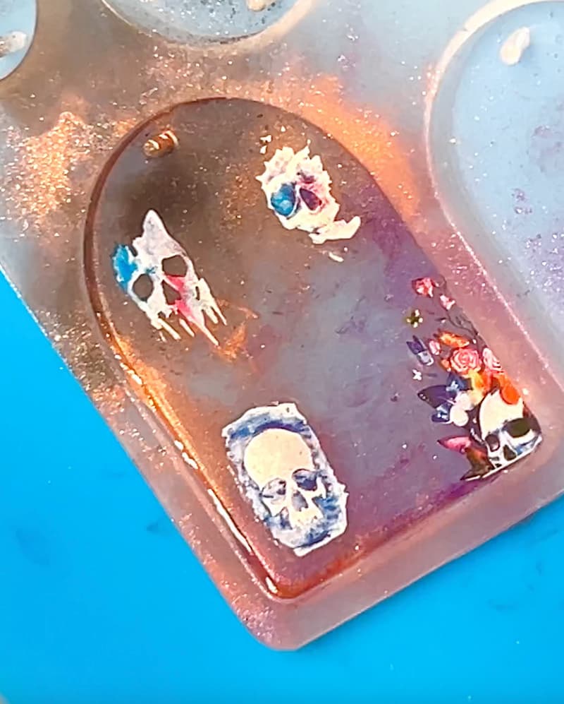 Adding skull nail stickers to the UV resin charm'