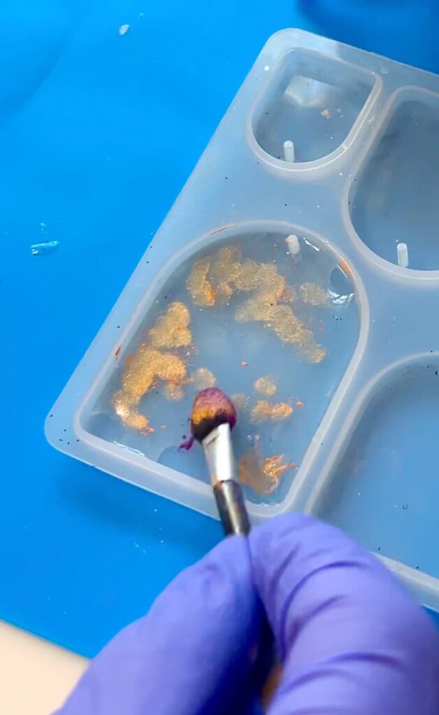 Dabbing pigment powders onto the UV resin for the skull charm