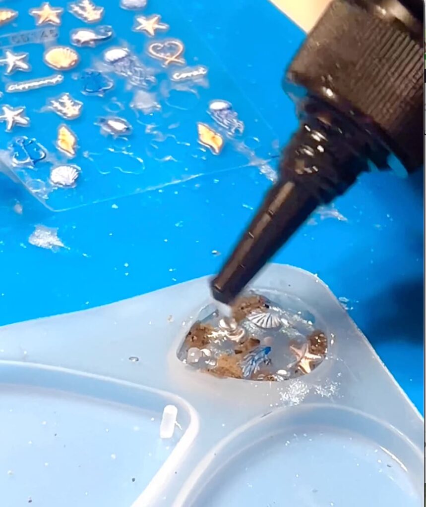 Adding UV resin to top off the mold and seal the UV resin earrings