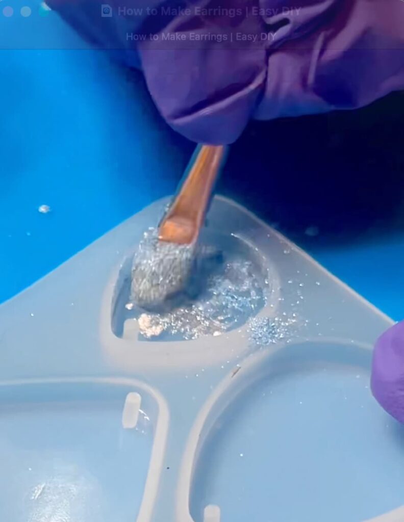 Dabbing pigment powder on the UV resin to show how to make earrings