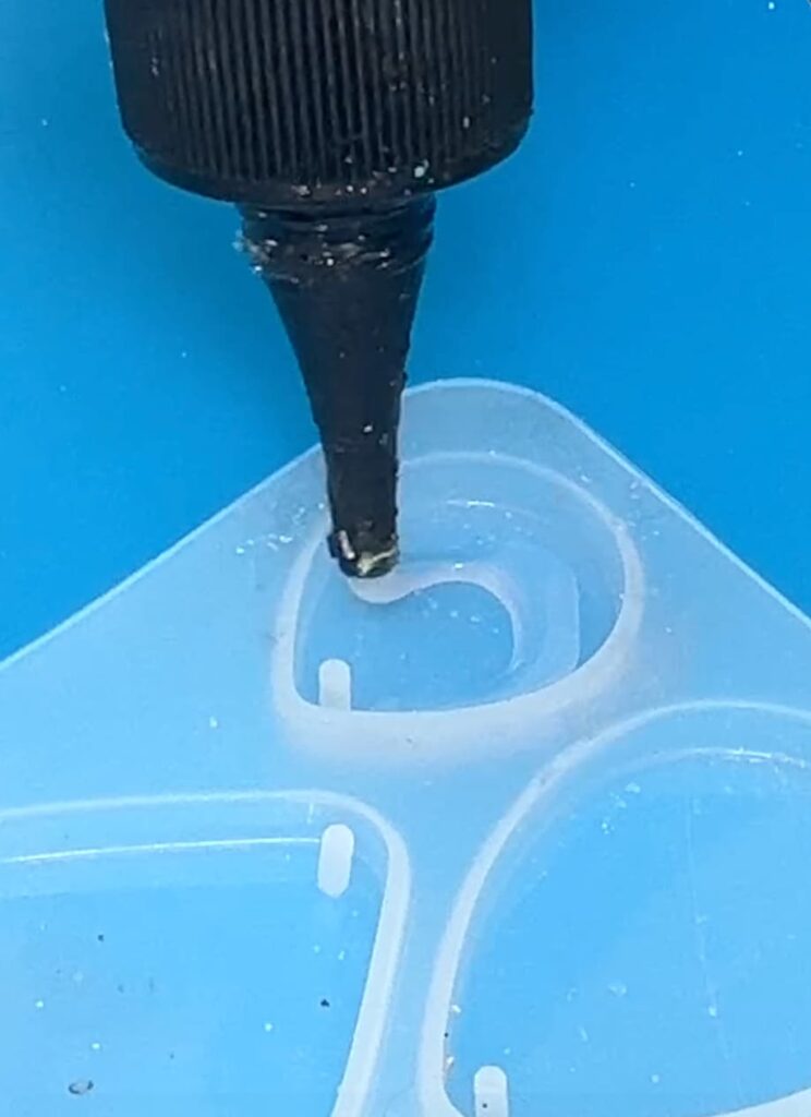 Putting UV resin into a teardrop silicone mold