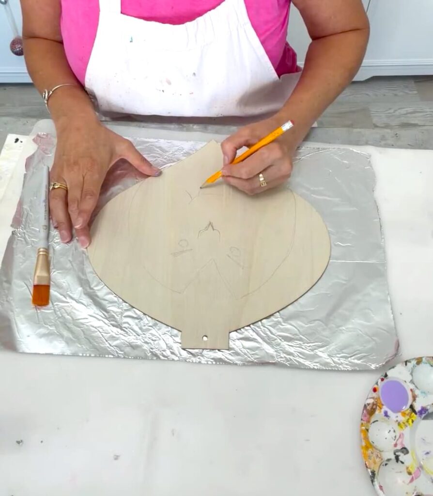 Sketch Dracula's face and features onto unfinished wood Dollar Tree Ornament