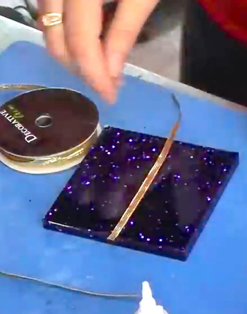 Adding gold ribbon to the homemade Christmas presents