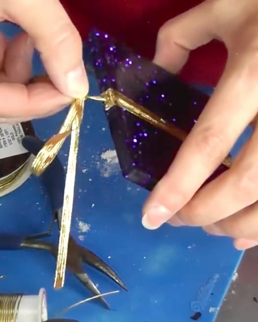 Inserting wire from the ribbon into the homemade Christmas present