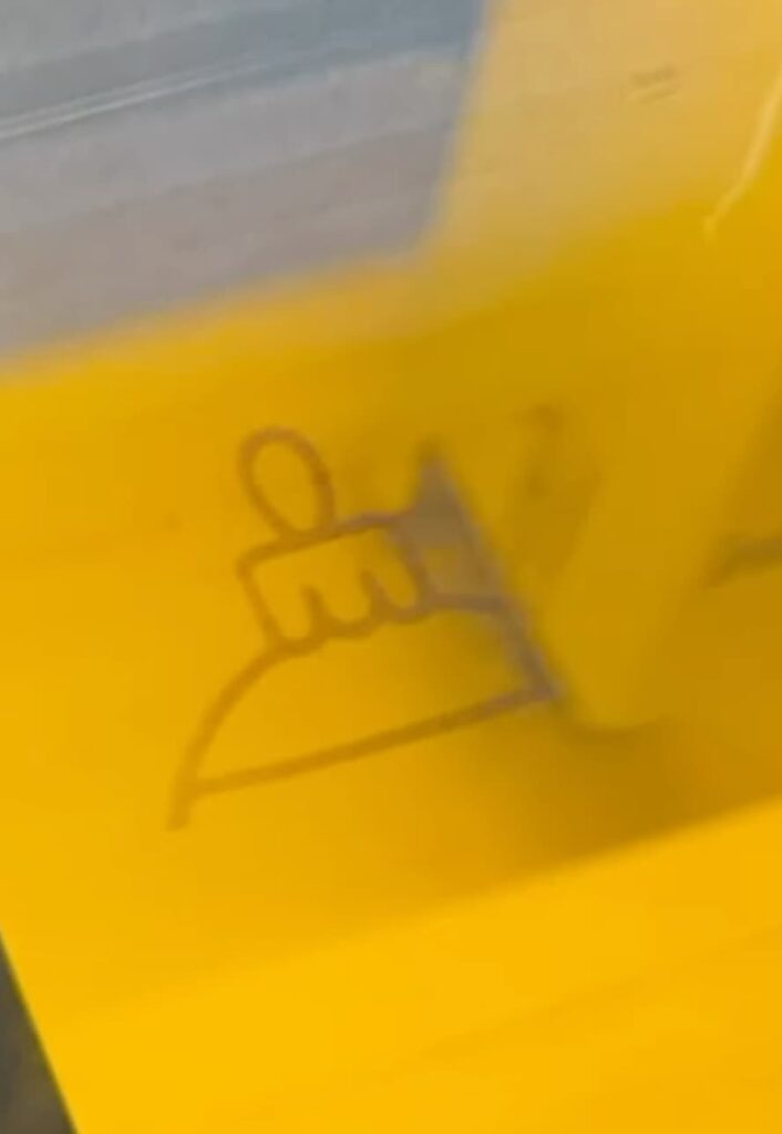 Laser engraver engraving the wood ornament