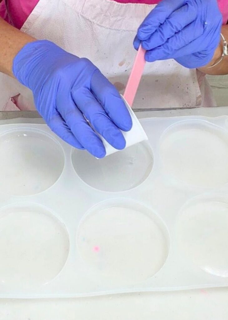 Pouring clear resin for the first layer of the snowman decor DIY