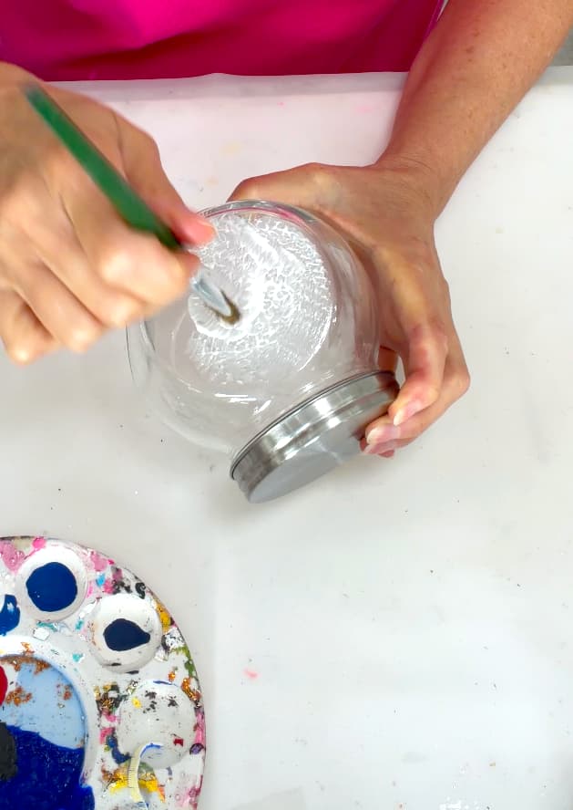 Painting the jar with white tempera paint