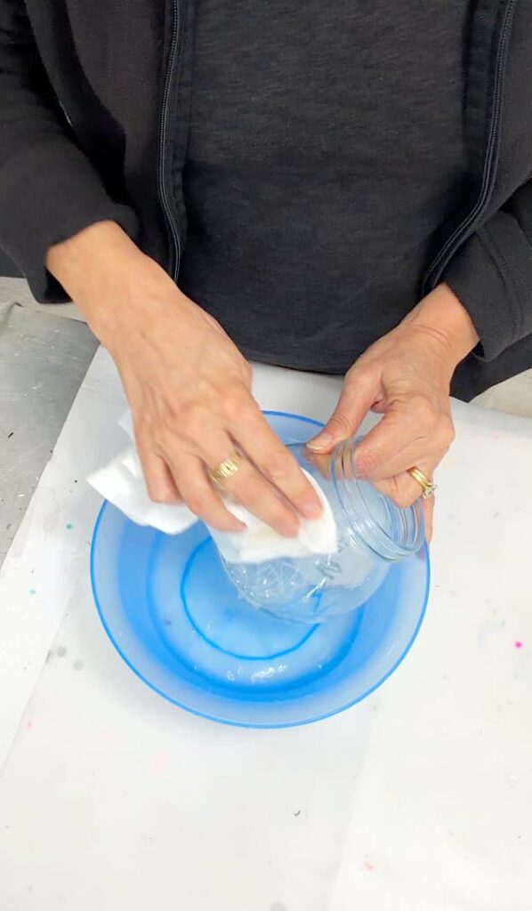 Washing the tempera paint off of the candy jar