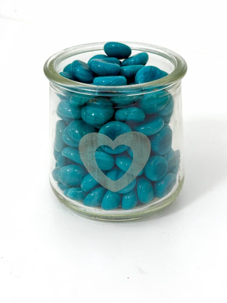 Laser engraving on Glass jar with engraved heart and turquoise pebbles in it