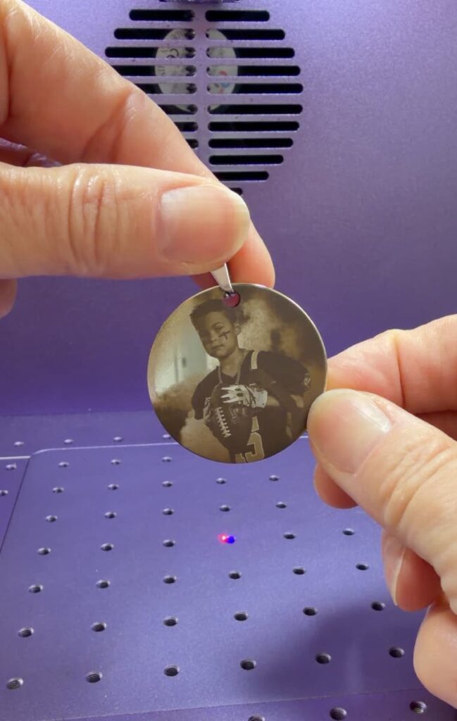 holding metal laser engraving a photo with added jump ring