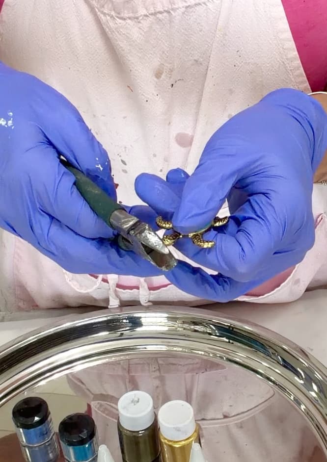 Clipping off the loop from the turtle charm for the resin ocean art tray