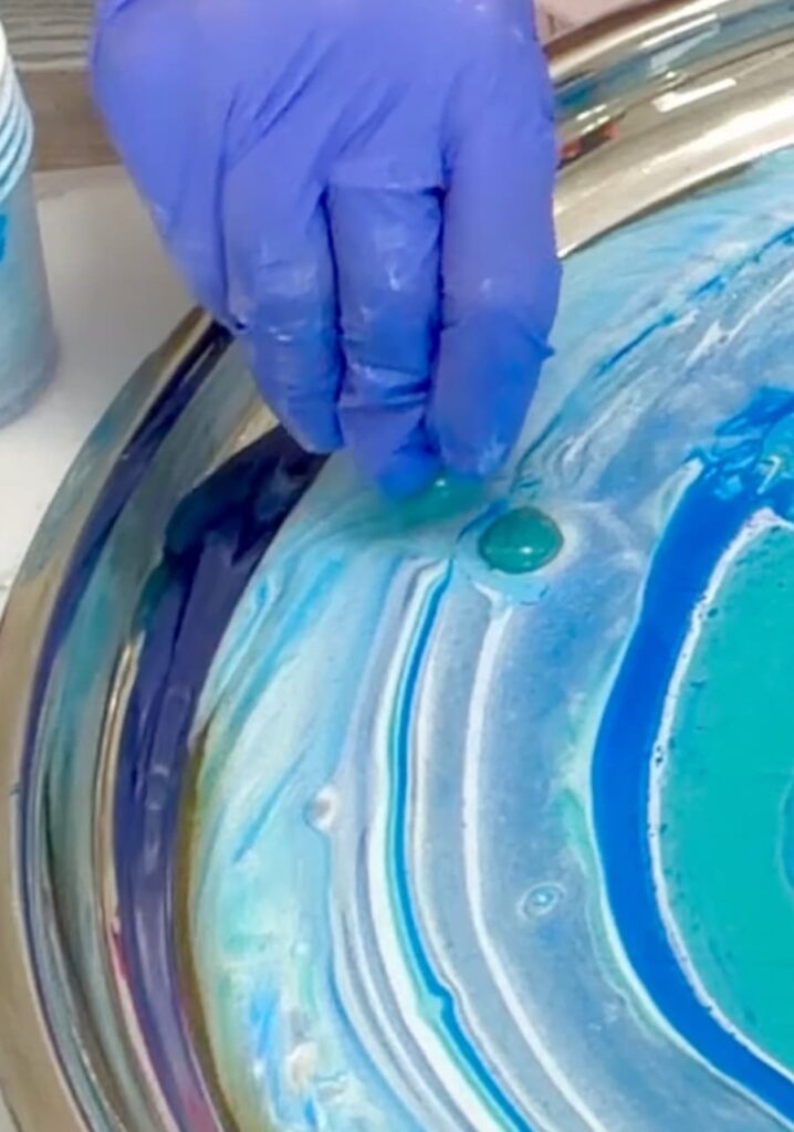 Dropping turquoise colored stones in resin