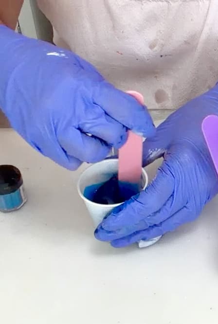 Mixing blue pigment into resin for the resin ocean art