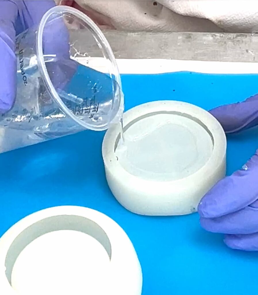 Pouring clear resin into the jar mold for the perfect wine lover gift