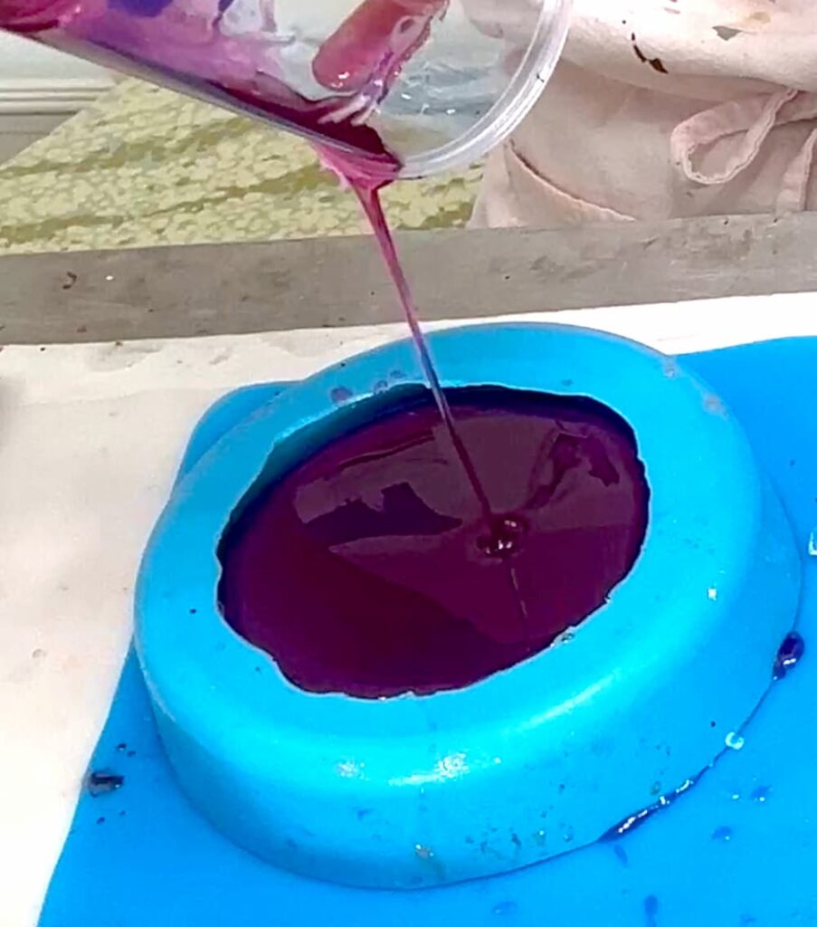 Pouring excess resin into a bowl mold