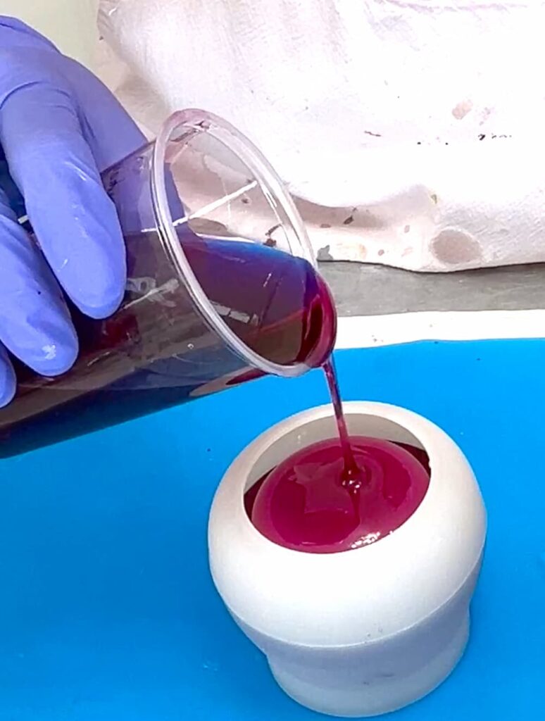 Pouring red resin into the base of the perfect wine lover gift