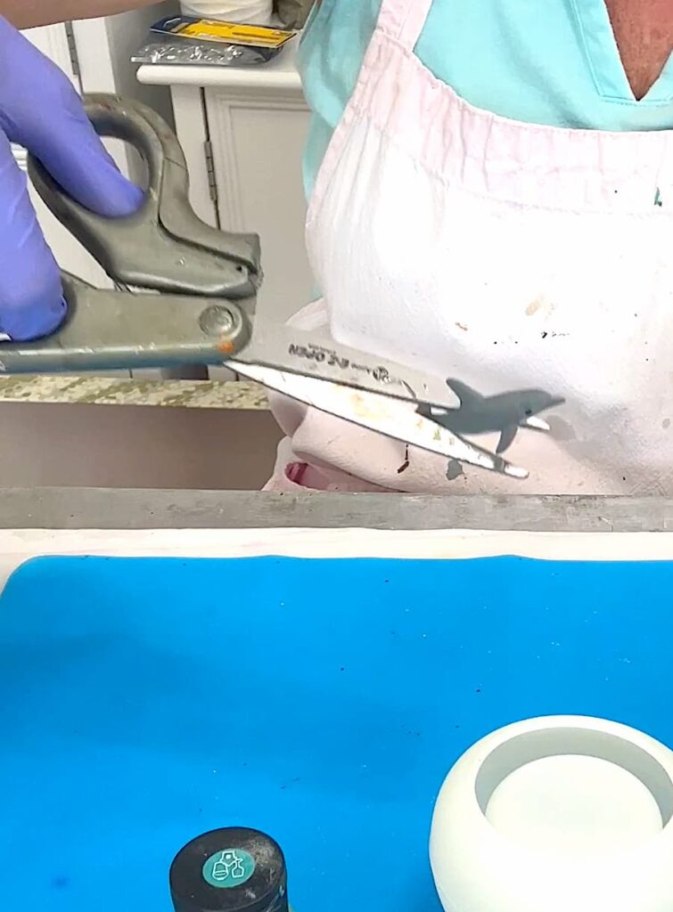 Toy dolphin in scissor blades
