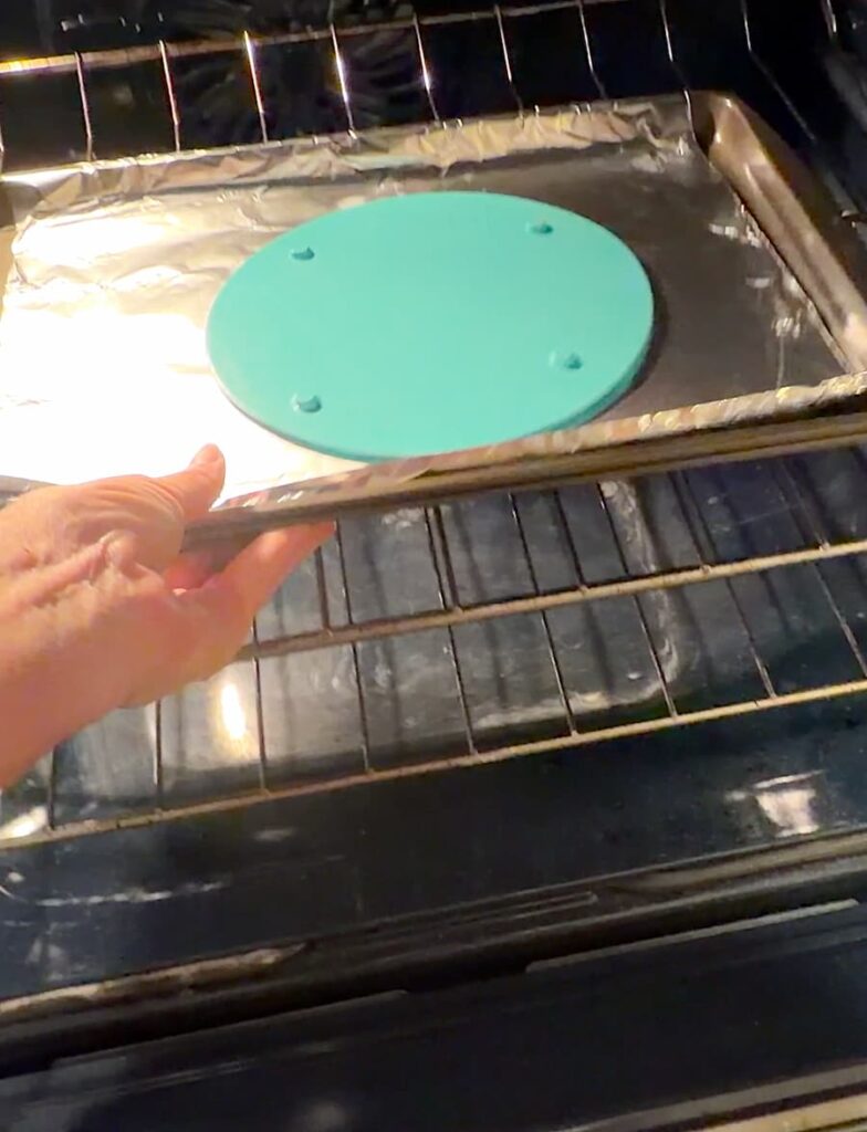 Putting round Dollar Tree cutting board into the oven