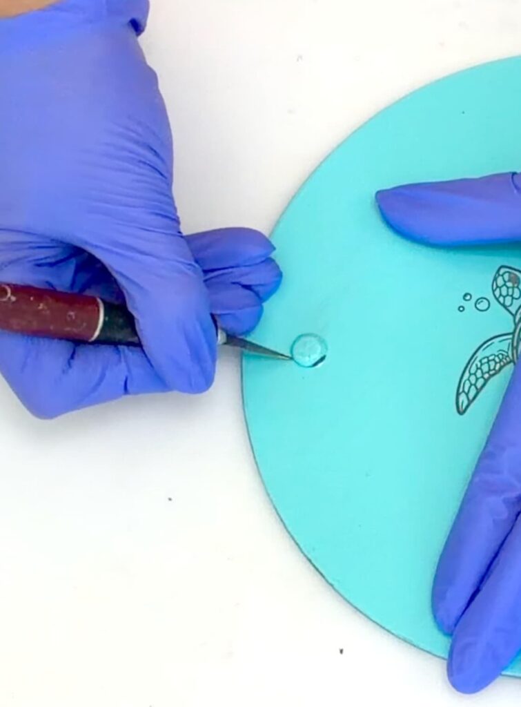 Using a craft knife to cut around the bumpers of the dollar tree cutting board