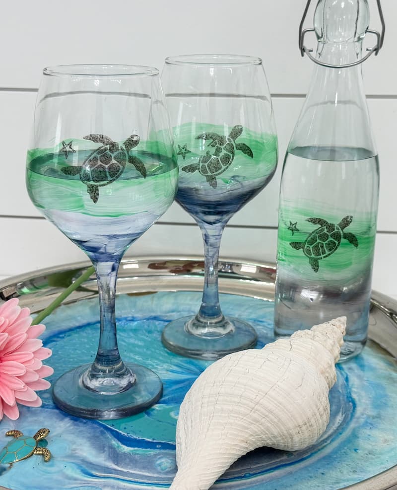 Finished coastal wine glass set that was decorated with glass paint