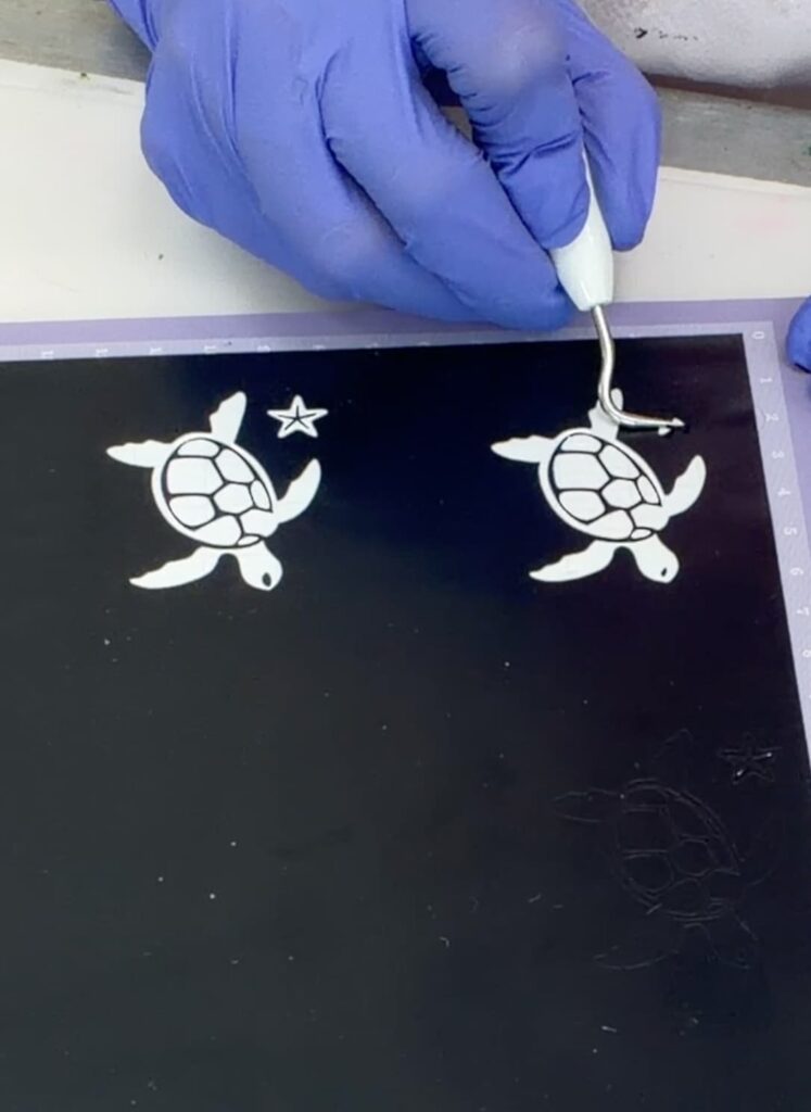 using a weeding tool to remove vinyl from stencil