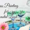 Coastal wine glass set and bottle on tray with a pink flower