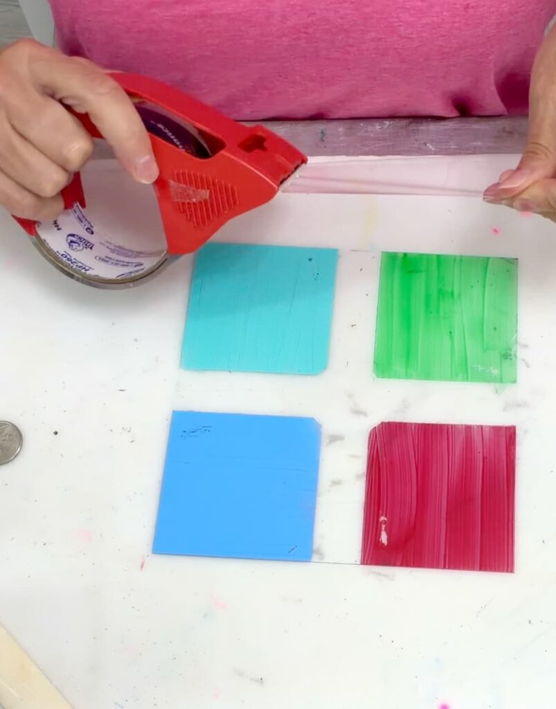 putting packing tape over glass to test for the best glass paint