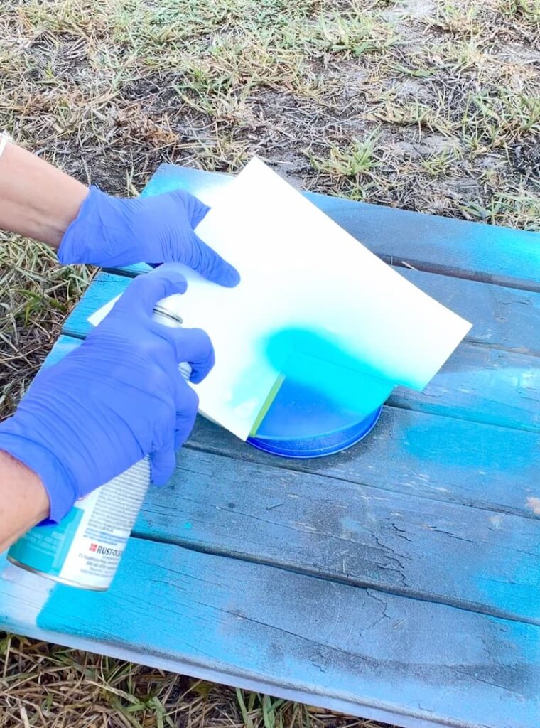 spraying spray paint on glass