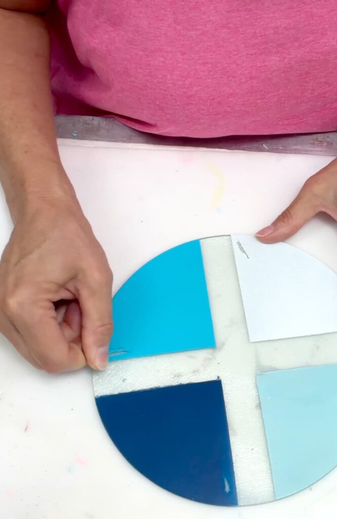 using a quarter to test for the best glass a paint by scraping the spray paint.