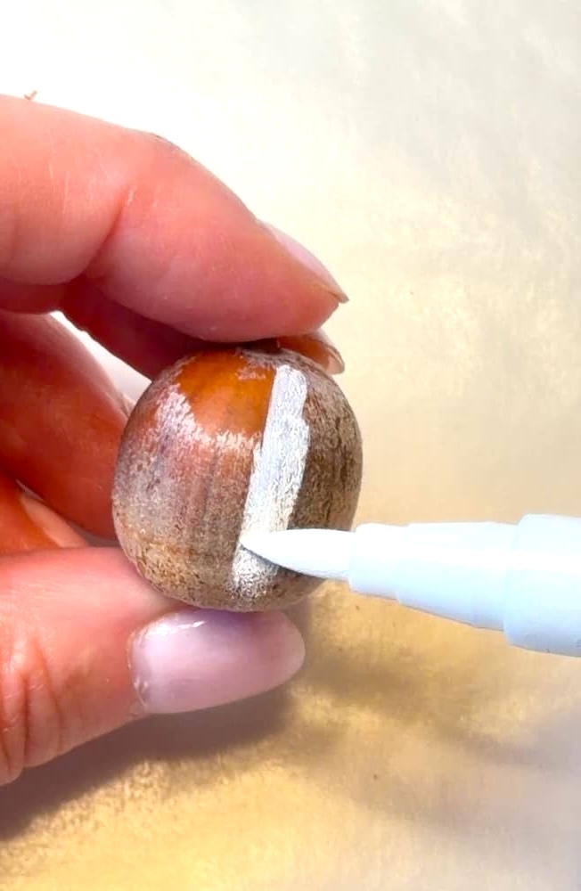 Coloring acorn white with acrylic marker for cute ghost