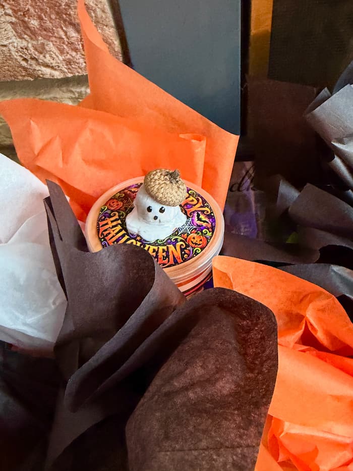 orange, black and white tissue paper around the acorn ghost