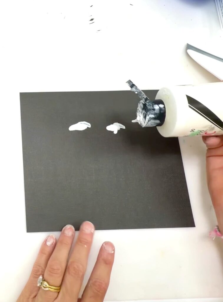 Easy paint idea ghost family portrait | squeezing white paint onto a black square of cardstock